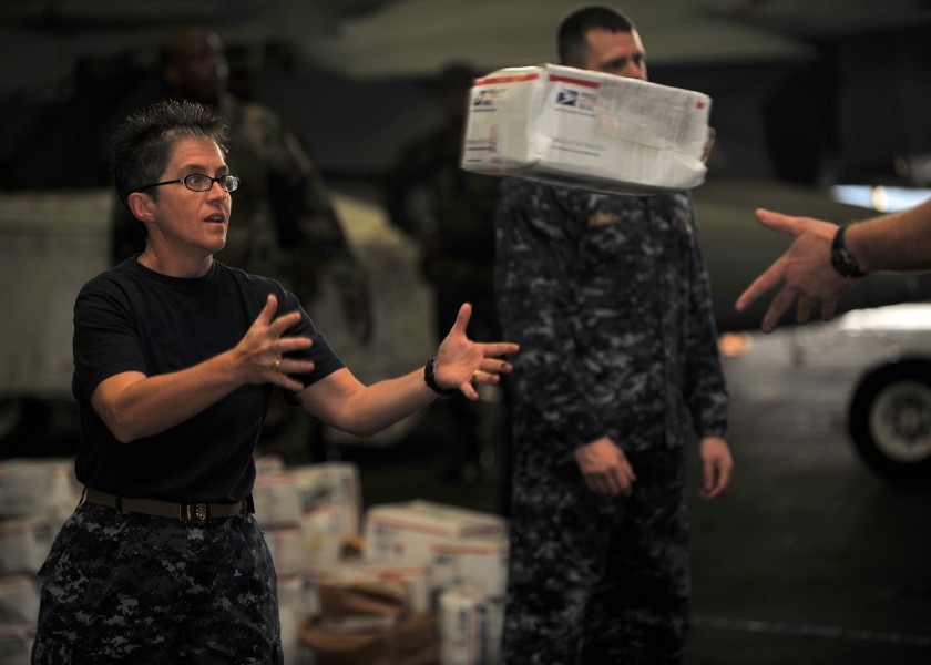 US Navy 101216-N-5016P-082 Master Chief Susan Whitman, command master chief aboard the aircraft carrier USS Abraham Lincoln (CVN 72), helps the shi
