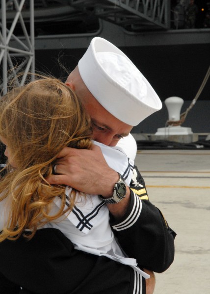 US Navy 110319-N-CH132-024 Aviation Structural Mechanic 1st Class Eric Anderson holds his daughter after a six-month deployment aboard the aircraft