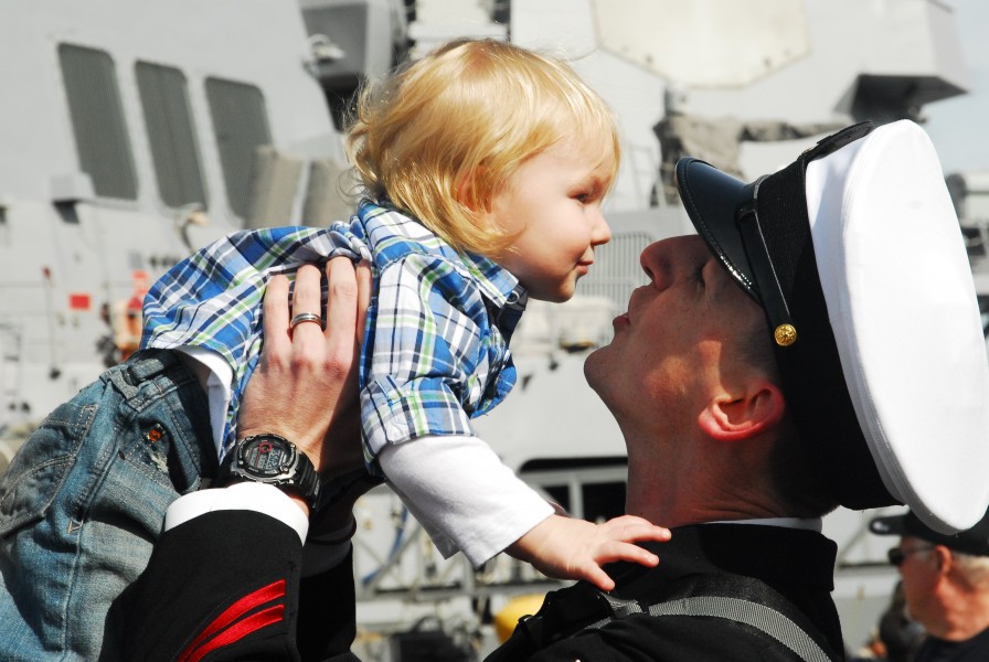 US Navy 110324-N-QW737-009 A chief petty officer greets his child upon arriving home aboard the aircraft carrier USS Abraham Lincoln (CVN 72)