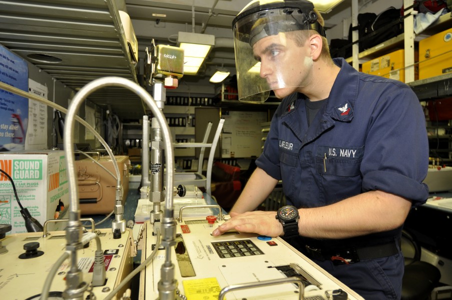 US Navy 110719-N-ZZ999-032 Machinist's Mate 2nd Class Matthew Lafleur, from Pequea, Pa., calibrates a pressure switch aboard the aircraft carrier U