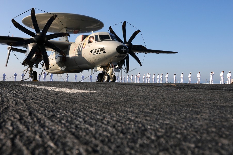 US Navy 110725-N-JN612-028 An E-2C Hawkeye sits on the flight deck of USS Abraham Lincoln (CVN 72) while Sailors man the rails