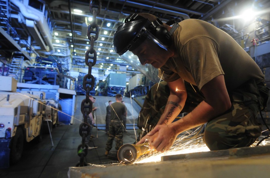 US Navy 110802-N-OS574-028 Electrician's Mate 2nd Class Neil Hutchison makes repairs on a landing craft utility assigned to Assault Craft Unit (ACU