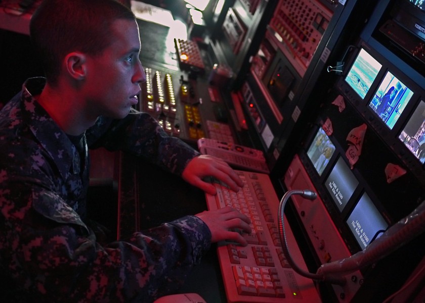 US Navy 110928-N-OE749-001 Mass Communication Specialist Seaman Zachary Welch updates a training schedule from the site TV control room