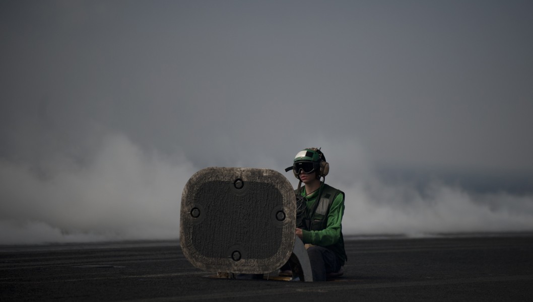US Navy 111011-N-TU221-383 A Sailor waits to release a catapult between launches aboard the Nimitz-class aircraft carrier USS Abraham Lincoln (CVN 