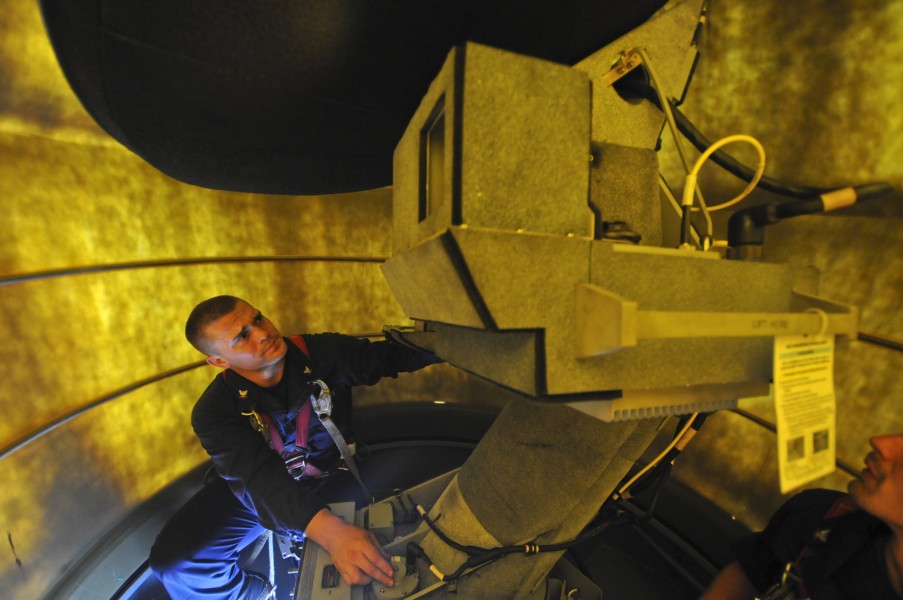 US Navy 111016-N-ZZ999-027 Electronics Technician 3rd Class Robert Taylor performs maintenance on a radar terminal aboard the guided-missile cruise