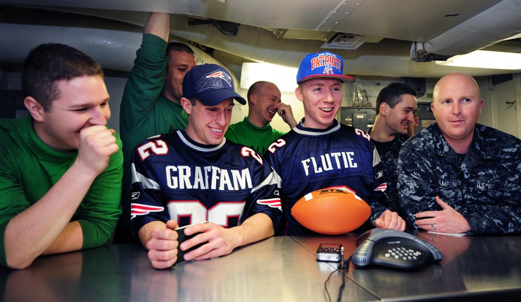 US Navy 111220-N-KQ416-059 Sailors talk to New England Patriots Head Coach Bill Belichick during a holiday morale phone call aboard the Nimitz-Clas
