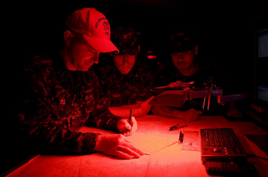 US Navy 120101-N-JN664-013 Lt. j.g. Jason Crile writes a New Year's Day poem in the ship's log book at the stroke of midnight on the bridge of the 