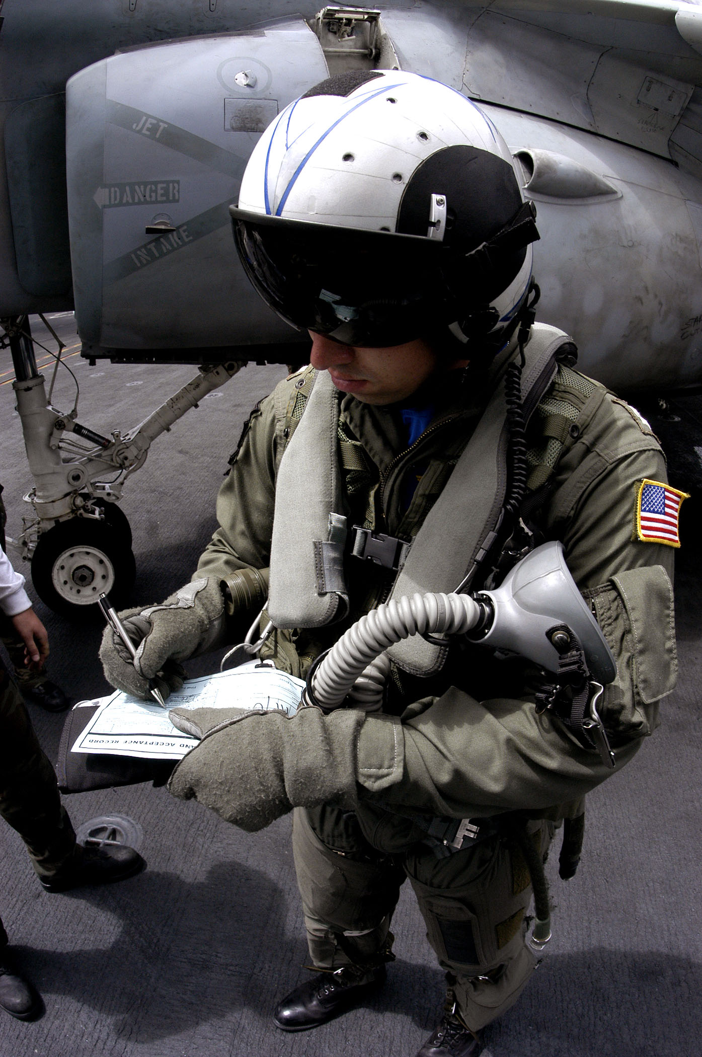 US Navy 030804-N-6213R-324 Lt. Mike Thompson signs a turn around card at the conclusion of his flight in an EA-6B Prowler
