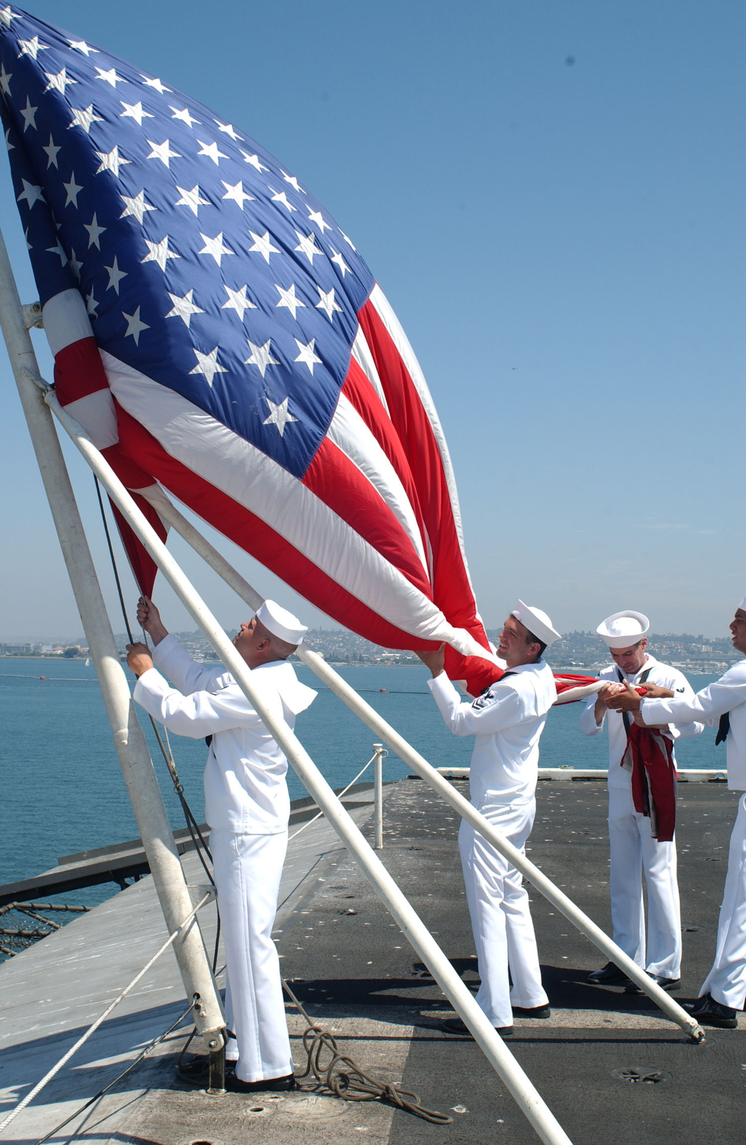 US Navy 030807-N-1356A-002 Sailors aboard USS Constellation (CV 64) lower the colors for the last time during the ships decommissioning ceremony