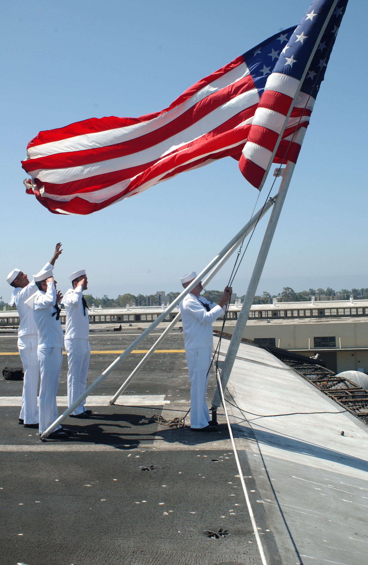 US Navy 030807-N-1356A-003 Sailors aboard USS Constellation (CV 64) lower the colors for the last time during the ships decommissioning ceremony