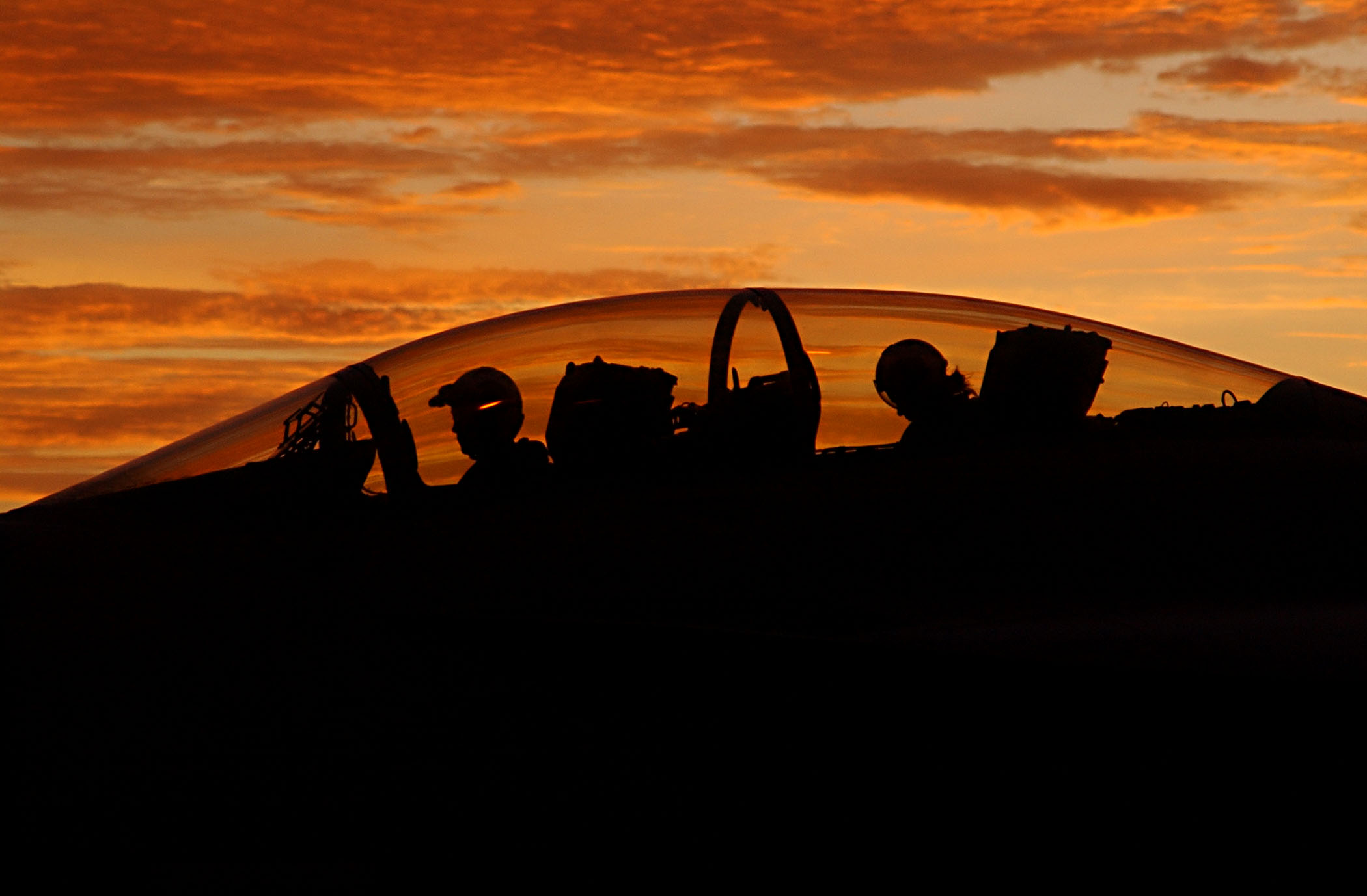 US Navy 030812-N-9769P-082 Silhouetted by a setting sun, the aircrew of an F-A-18F Super Hornet assigned to the 