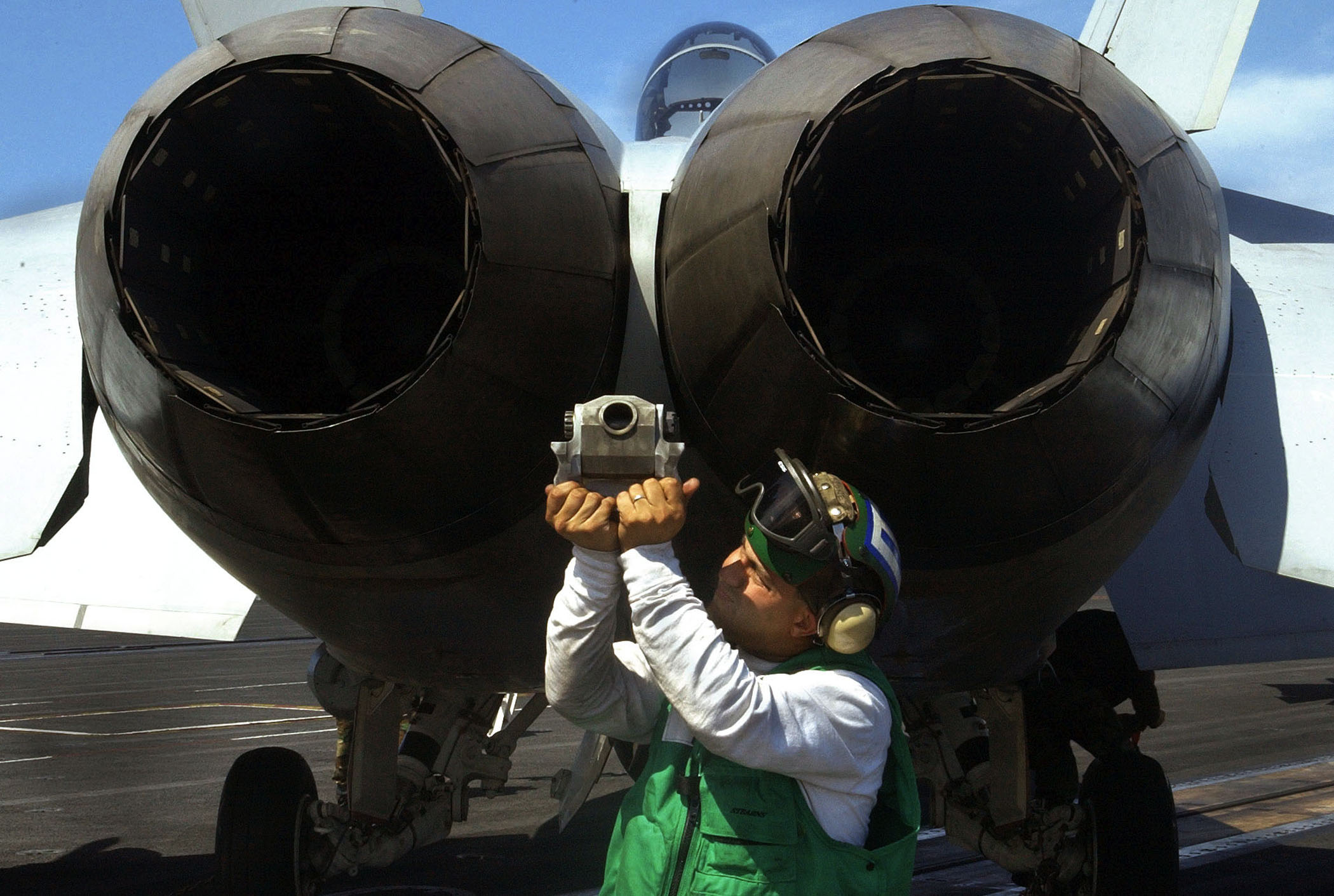 US Navy 030813-N-7732W-062 Aviation Structural Mechanic 2nd Class Guillerimo Brunetti, from Berrien Springs, Mich., performs a final maintenance check on the tailhook of an F-A-18F Super Hornet