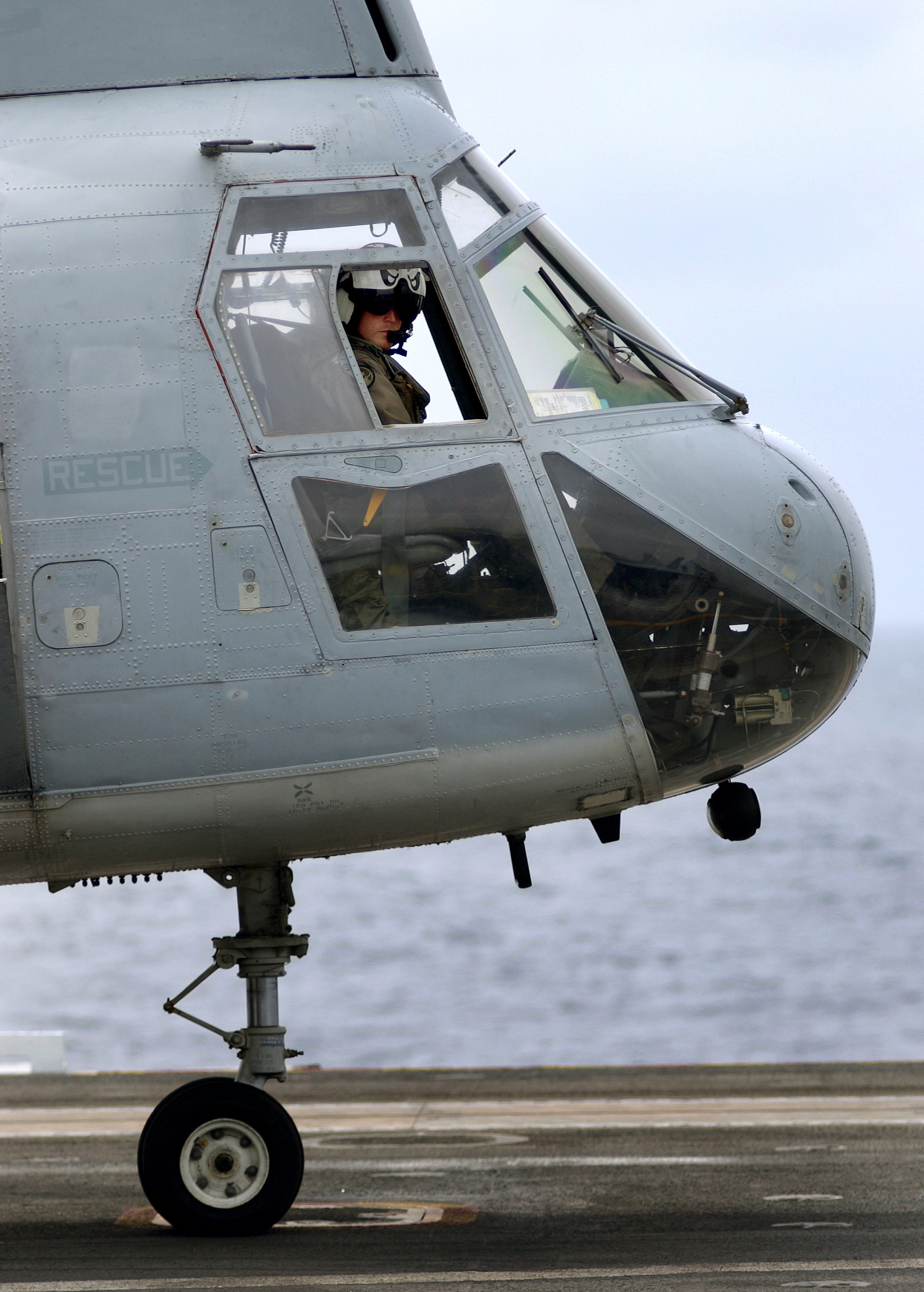 US Navy 030923-N-6213R-059 A pilot assigned the Gunbearers of Helicopter Combat Support Squadron Eleven (HC-11) waits to be given the signal to start engines