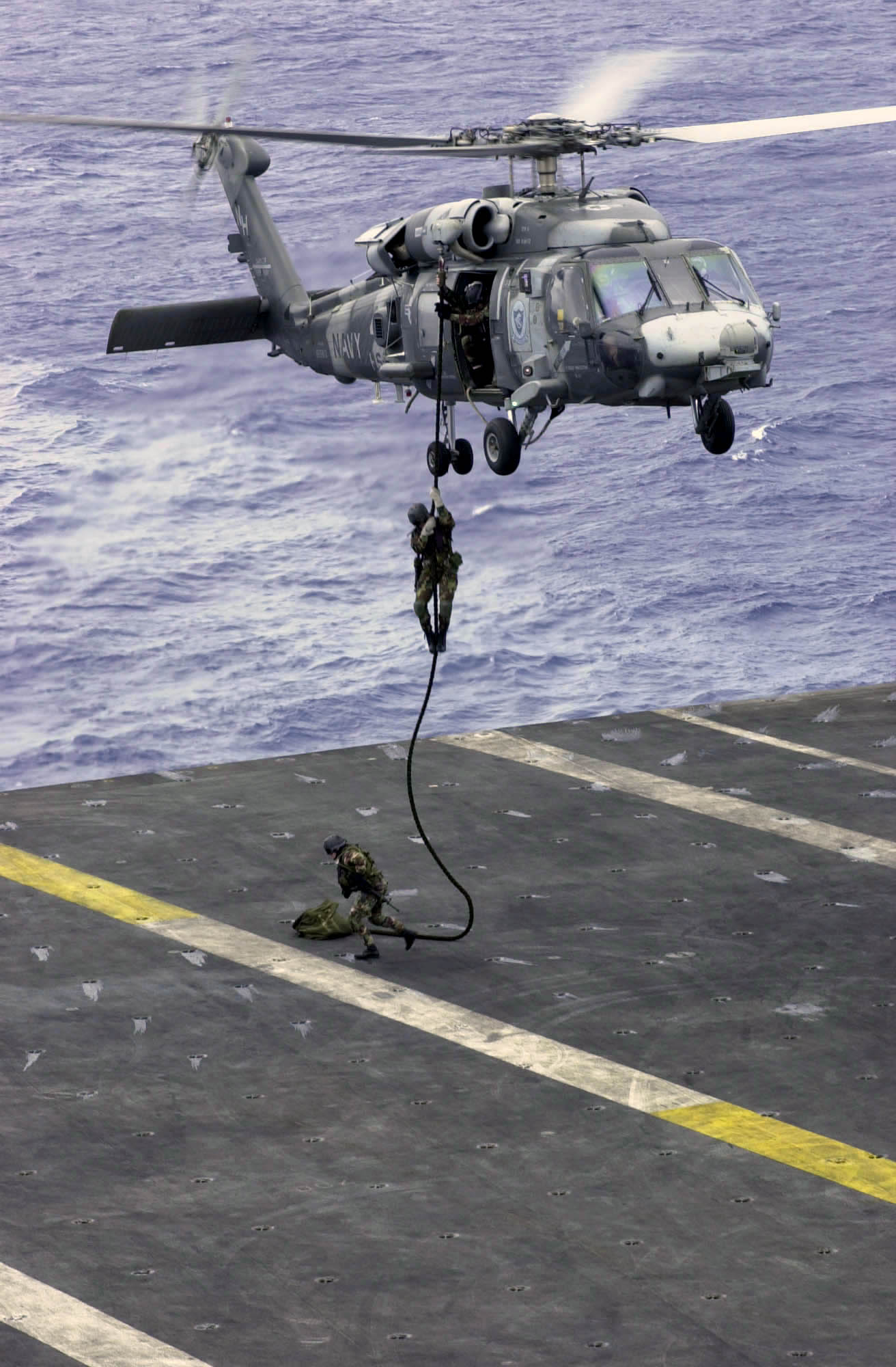 US Navy 031017-N-2143T-002 Explosive Ordinance Disposal Mobile Unit Eleven Detachment One (EOD MU11 DET 1) fast ropes out of a HH-60H Seahawk 