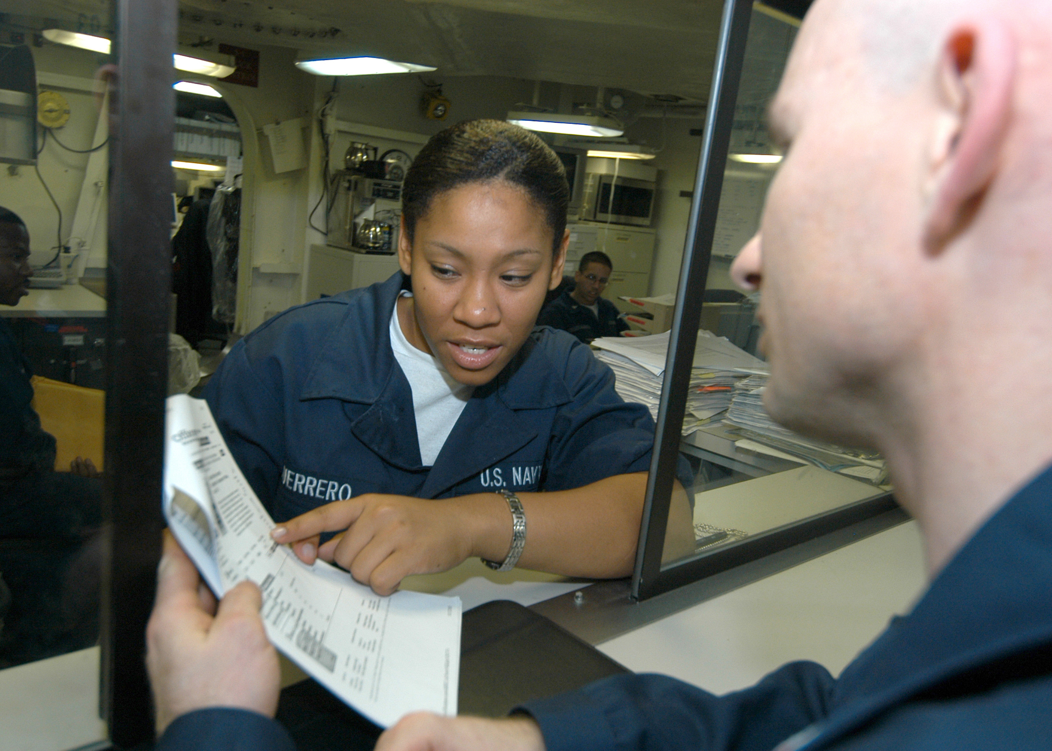 US Navy 031110-N-7090S-001 Storekeeper Seaman Apprentice Yudi Guerrero from Bronx, N.Y. helps a customer order supplie