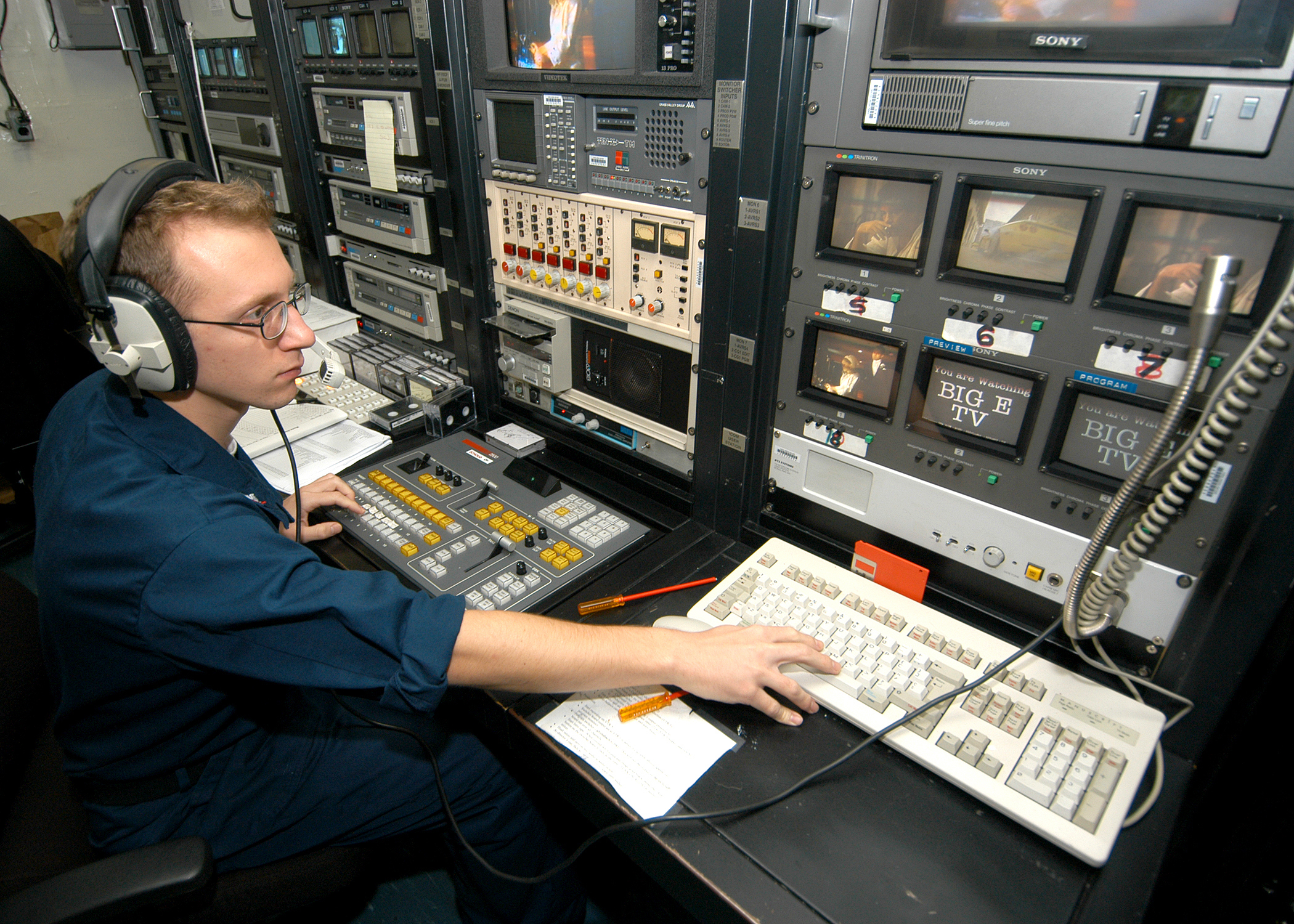 US Navy 031231-N-7408M-002 Journalist 3rd Class Daniel W. Vaughn from Stafford, Va., monitors the ship's closed circuit television system aboard USS Enterprise (CVN 65)