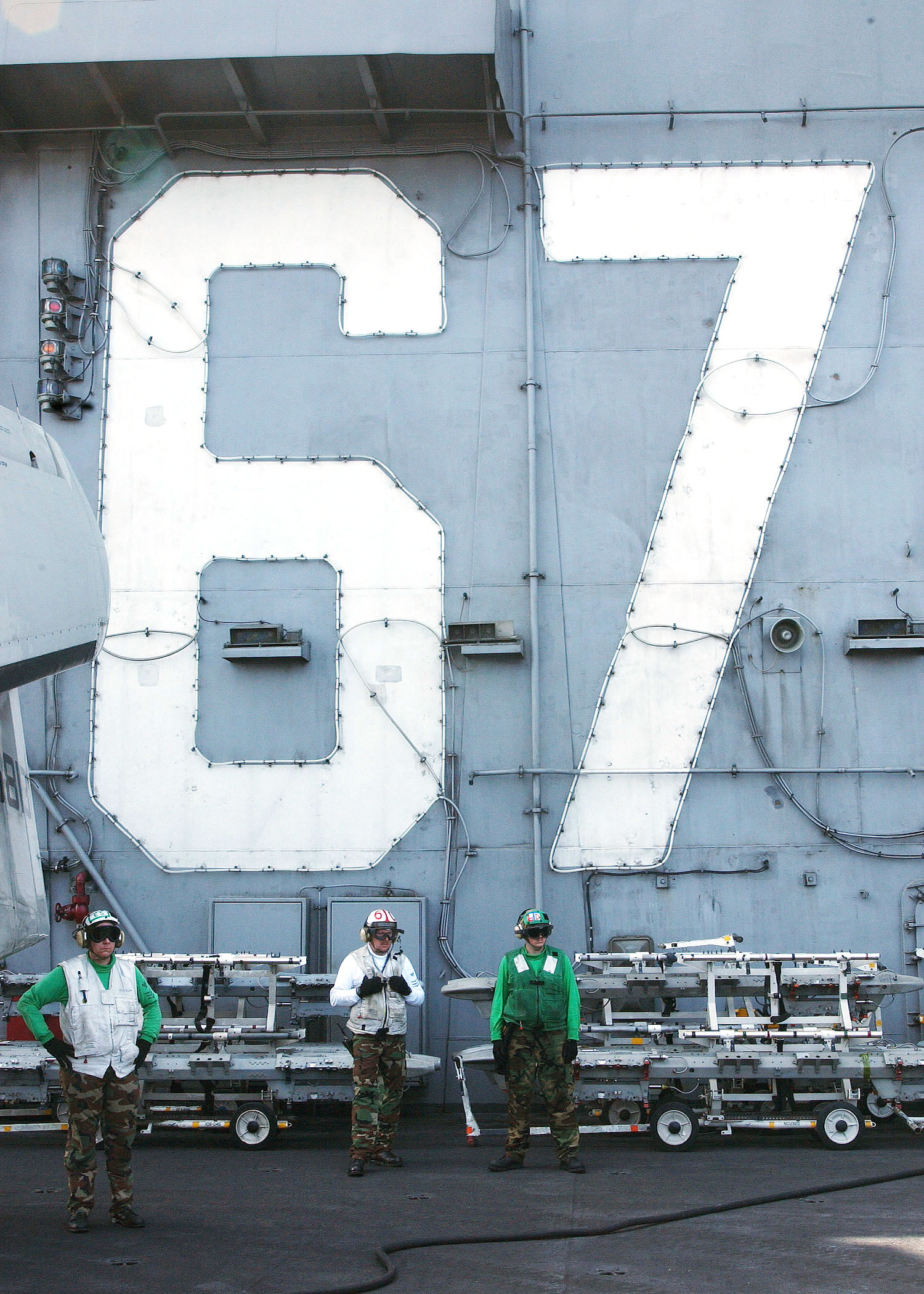 US Navy 040306-N-4374S-010 Sailors observe flight operations while standing in front of the island superstructure aboard the aircraft carrier John F. Kennedy
