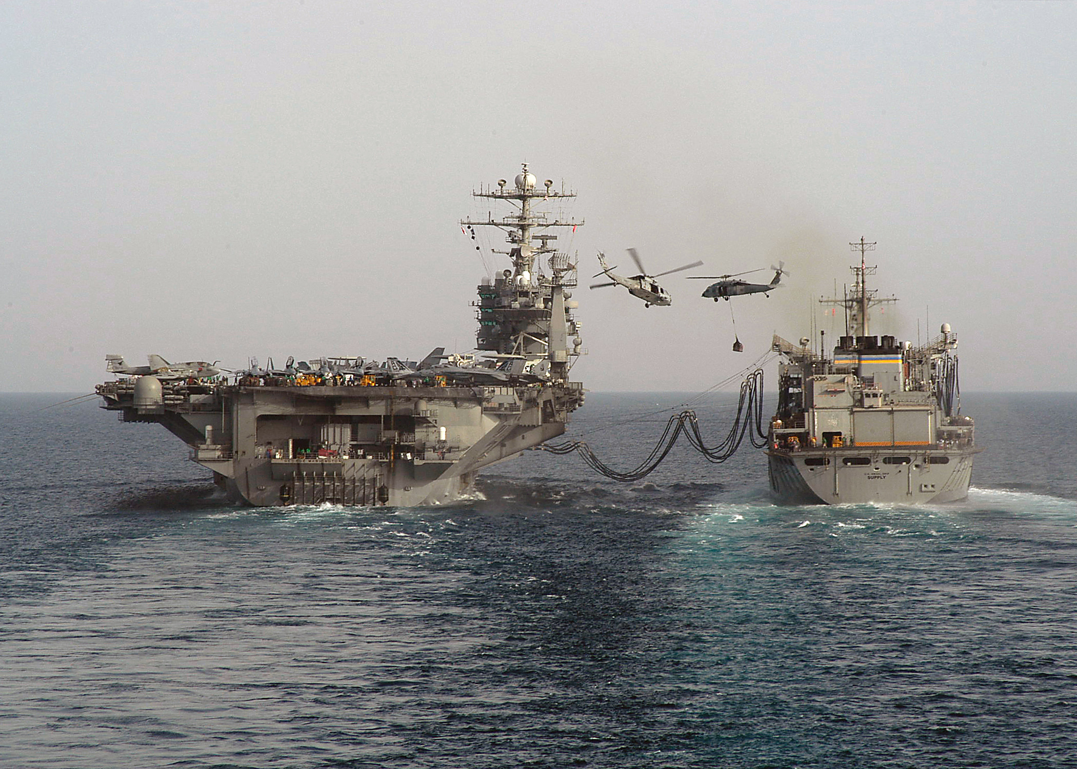 US Navy 040422-N-9630B-010 The Military Sealift Command (MSC) fast combat support ship USNS Supply (T-AOE 6) and USS George Washington (CVN 73) perform a connected replenishment at sea (RAS)