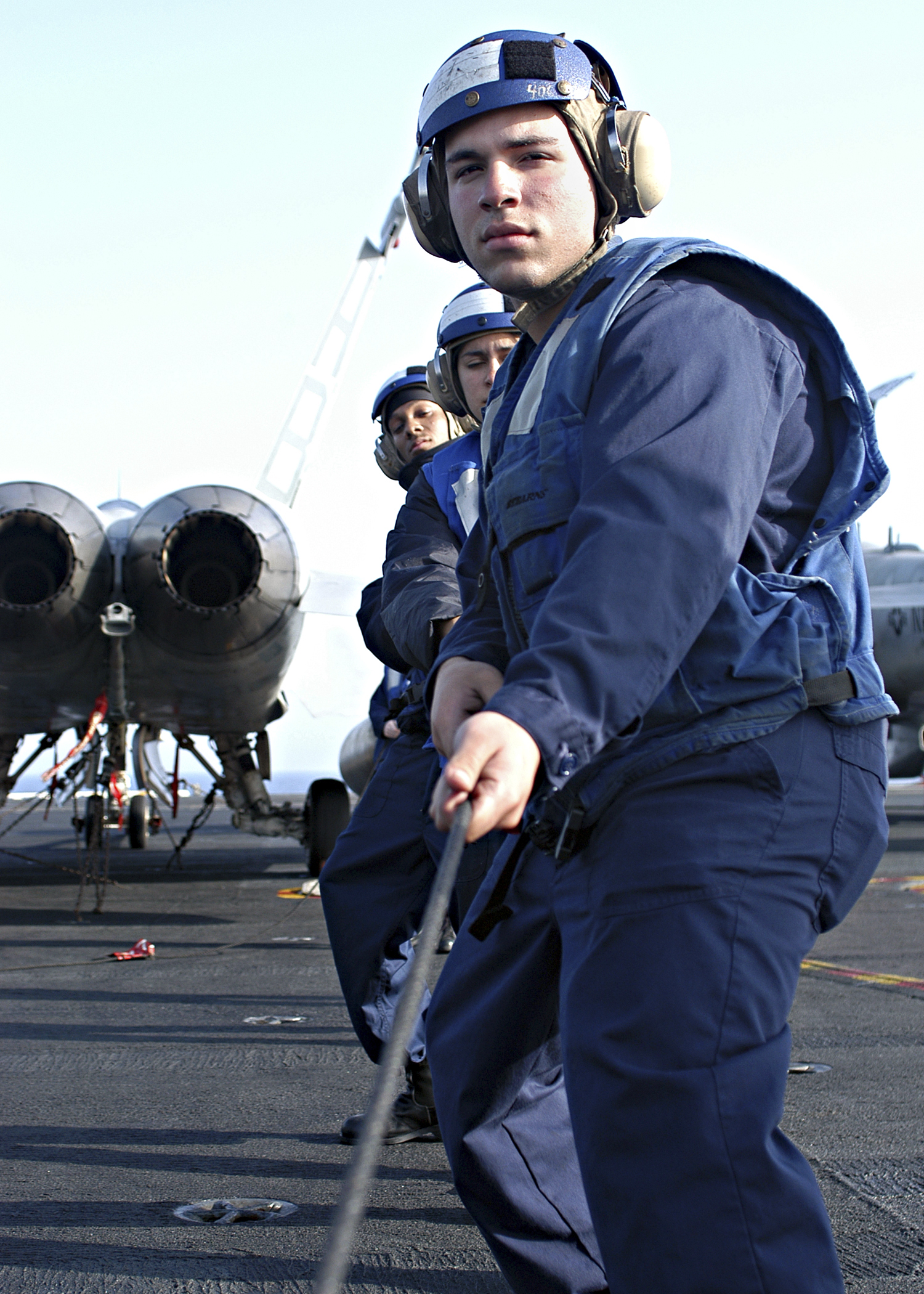 US Navy 040612-N-6293B-016 Seaman Rafael Tianeo of Manhattan, N.Y. and other Sailors hold the phone-and-distance line, establishing ship-to-ship communication 