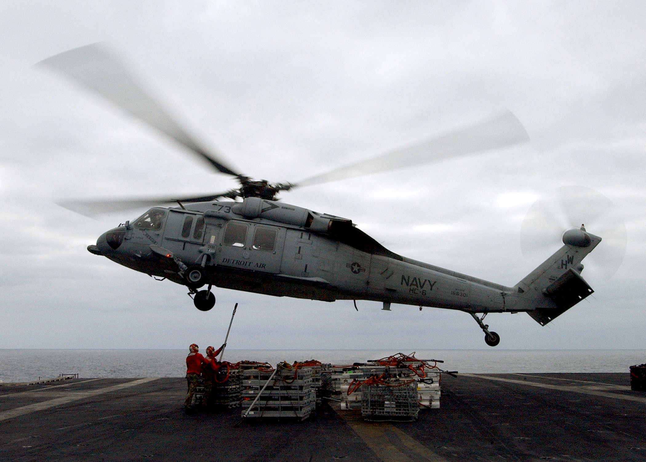 US Navy 040716-N-7532C-009 A MH-60 Knighthawk assigned to the Chargers of Helicopter Combat Support Squadron Six (HC-6) delivers supplies during a replenishment at sea (RAS) aboard USS Harry S. Truman (CVN 75)