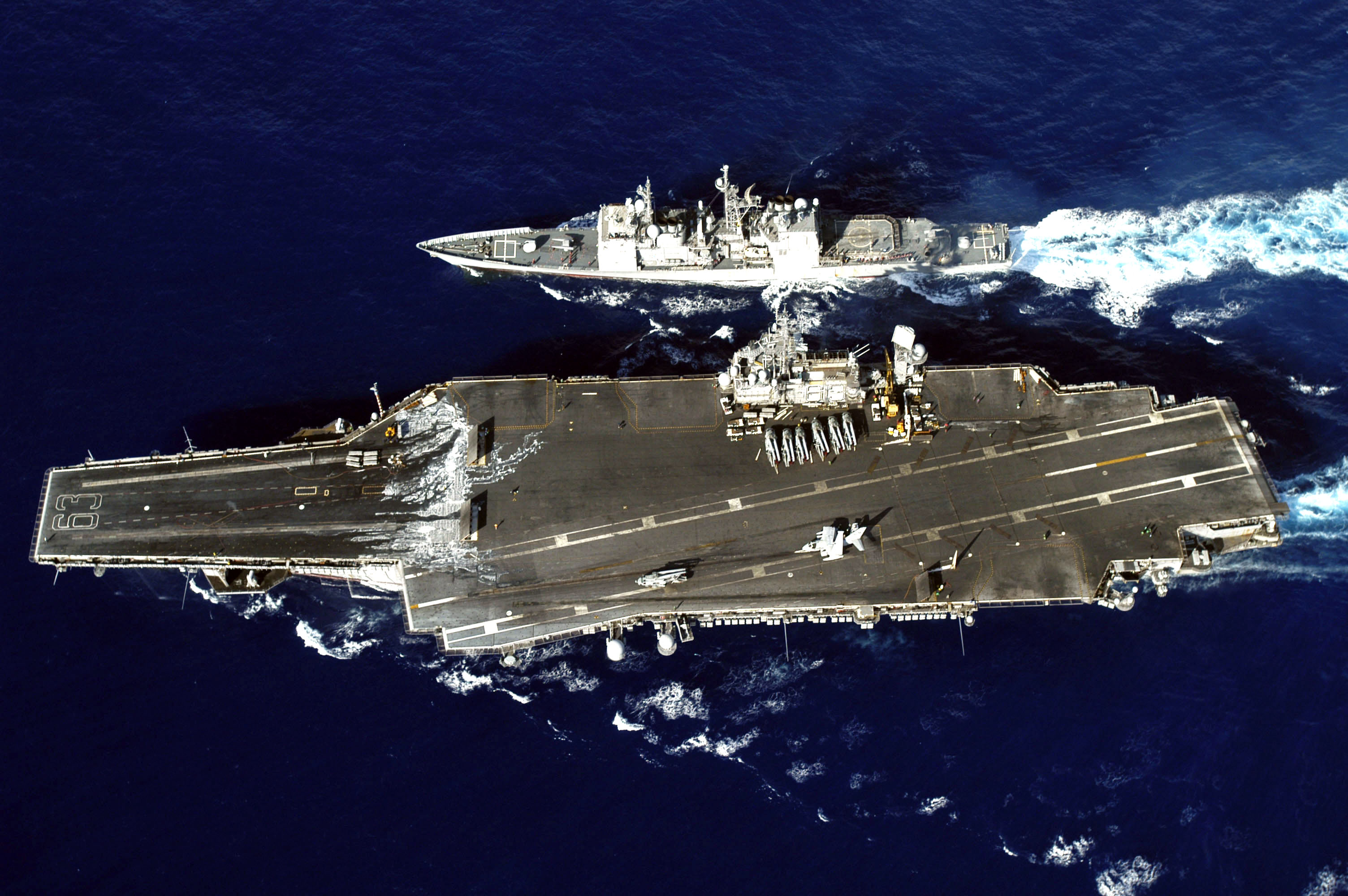 US Navy 040904-N-0120R-037 The Ticonderoga-class cruiser USS Vincennes (CG 49) and the conventionally powered aircraft carrier USS Kitty Hawk (CV 63) perform a replenishment at sea (RAS)