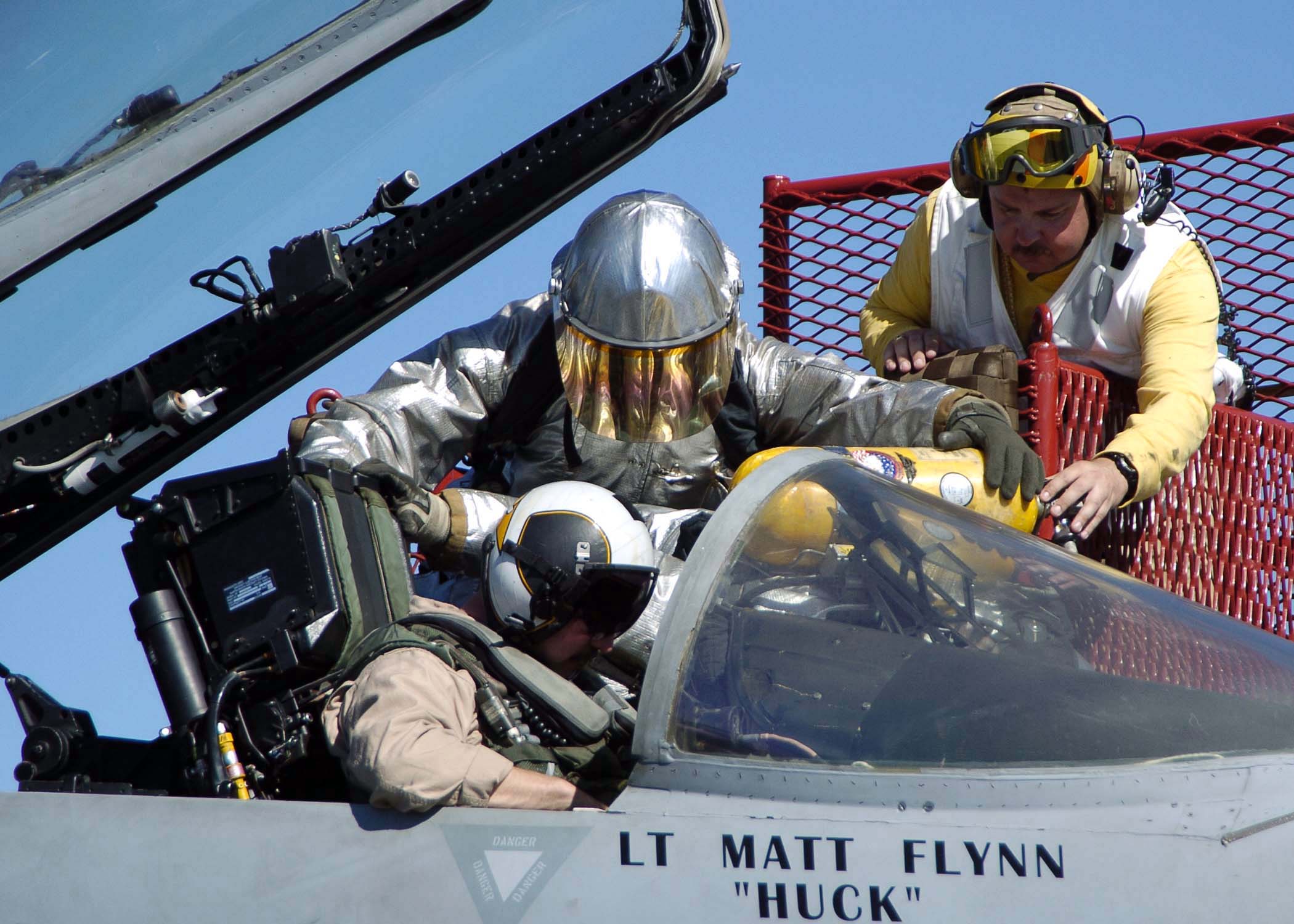 US Navy 041118-N-0057P-063 Firefighters remove the pilot of an F-A-18C Hornet during an aircraft fire training exercise on the flight deck aboard the Nimitz-class aircraft carrier USS Abraham Lincoln (CVN 72)