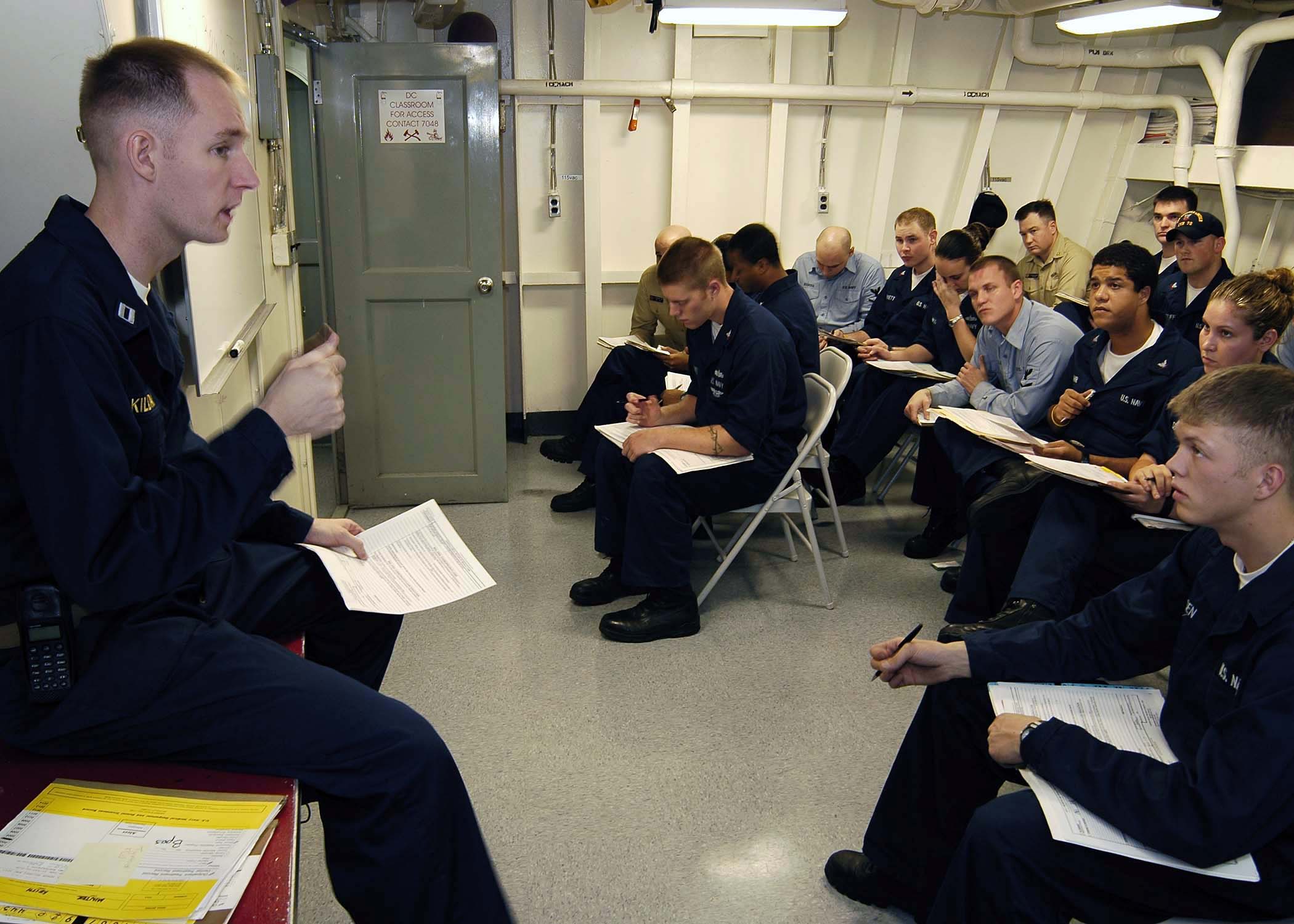 US Navy 050101-N-4166B-033 Lt. Jeremy Kilday conducts a health brief for sailors aboard USS Abraham Lincoln (CVN 72)