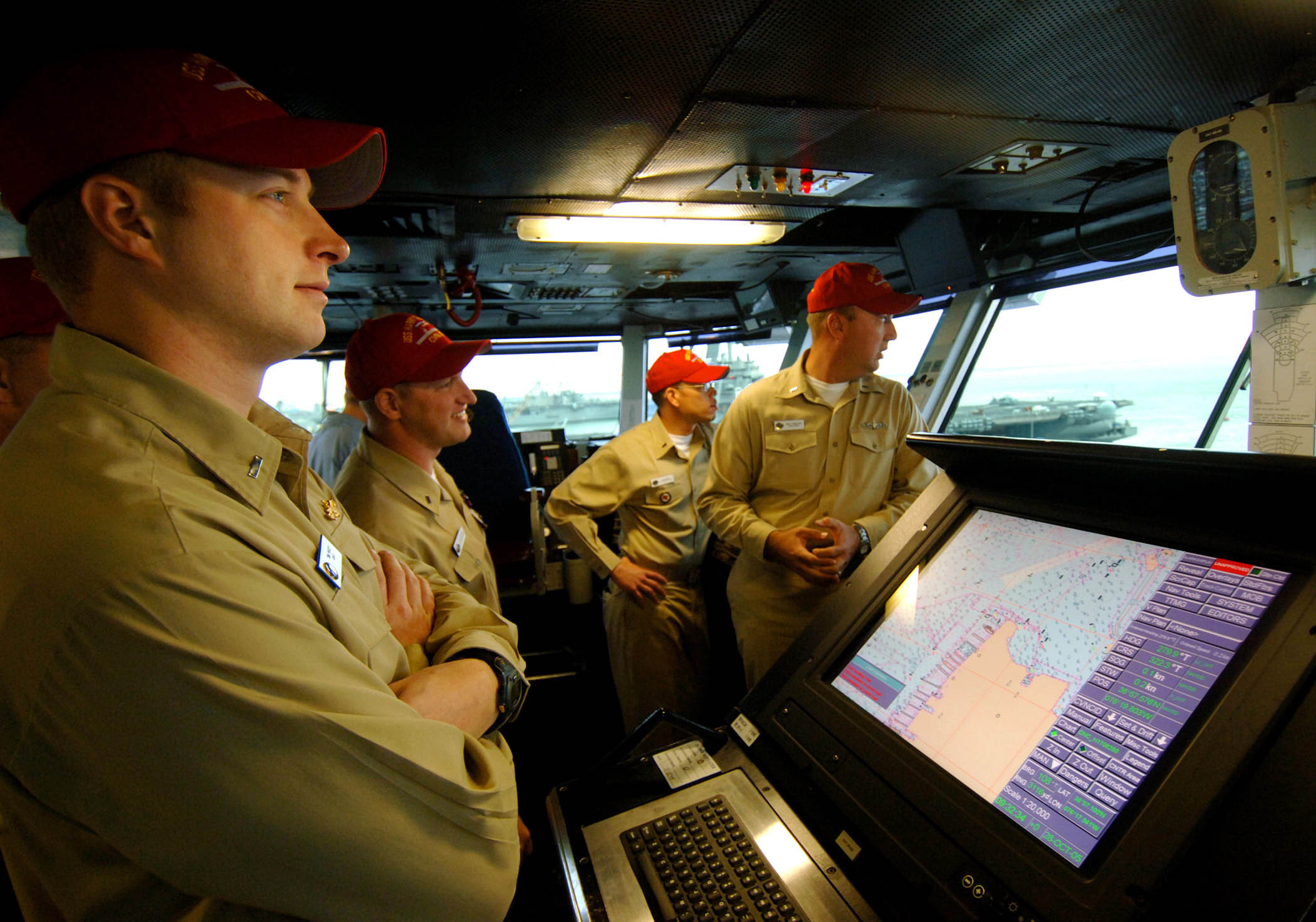 US Navy 051028-N-2984R-002 Officers of the deck look over the pier at Naval Station Norfolk from the navigation bridge