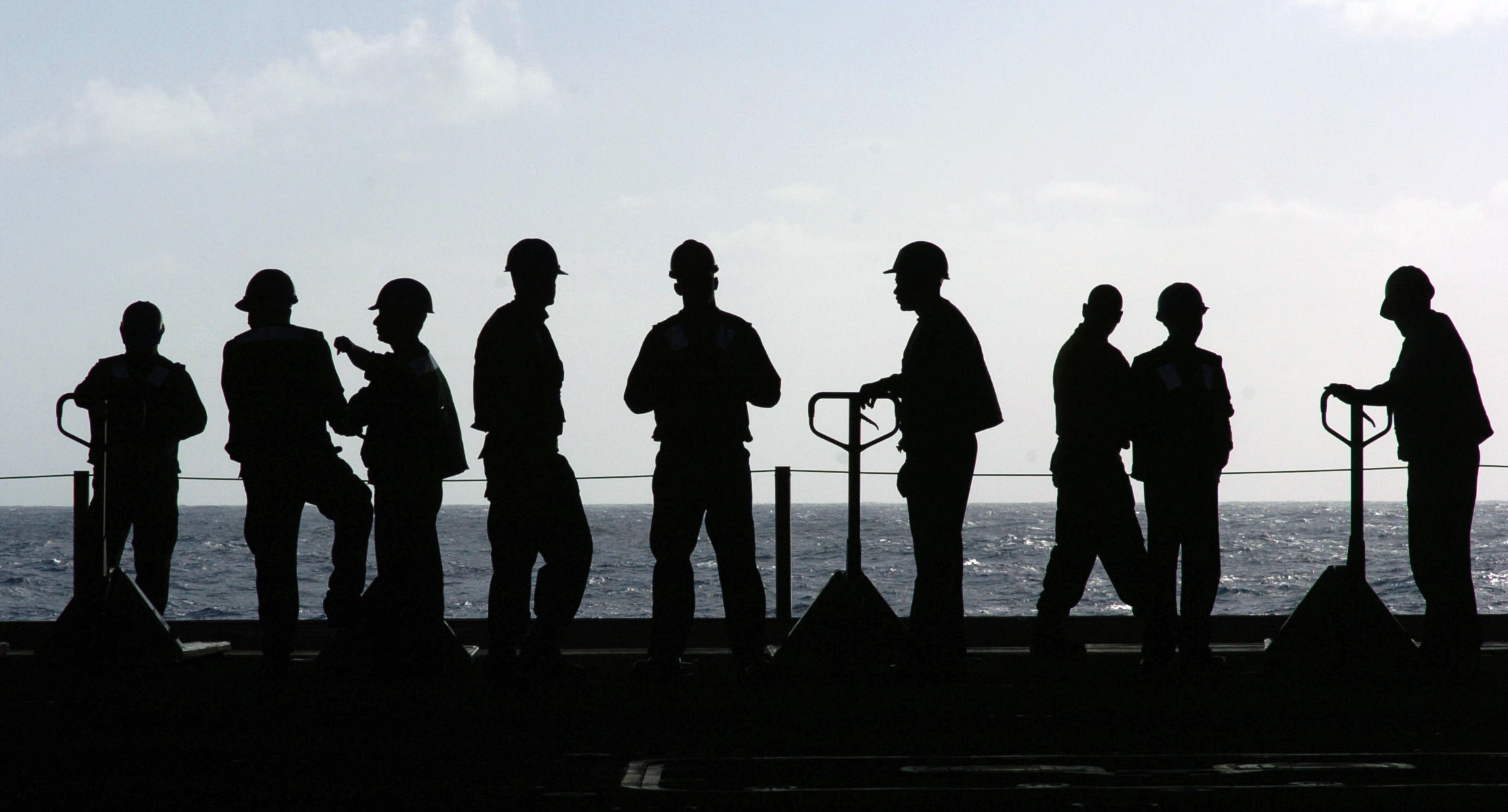 US Navy 060113-N-7130B-127 Sailors aboard the Nimitz-class aircraft carrier USS Ronald Reagan (CVN 76) wait for the next load of stores to be transported from the flight deck to the hangar bay
