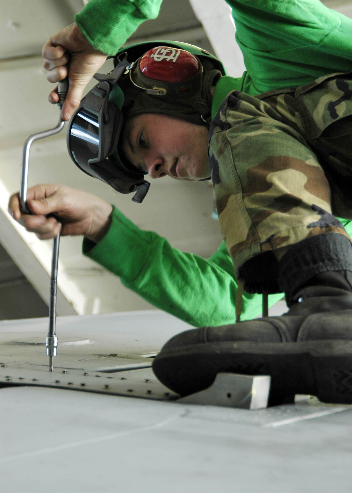 US Navy 060115-N-7981E-015 Airman Jake Edinger conducts repairs on the wing of an EA-6B Prowler assigned to the Lancers of Electronic Attack Squadron One Three One (VAQ-131)