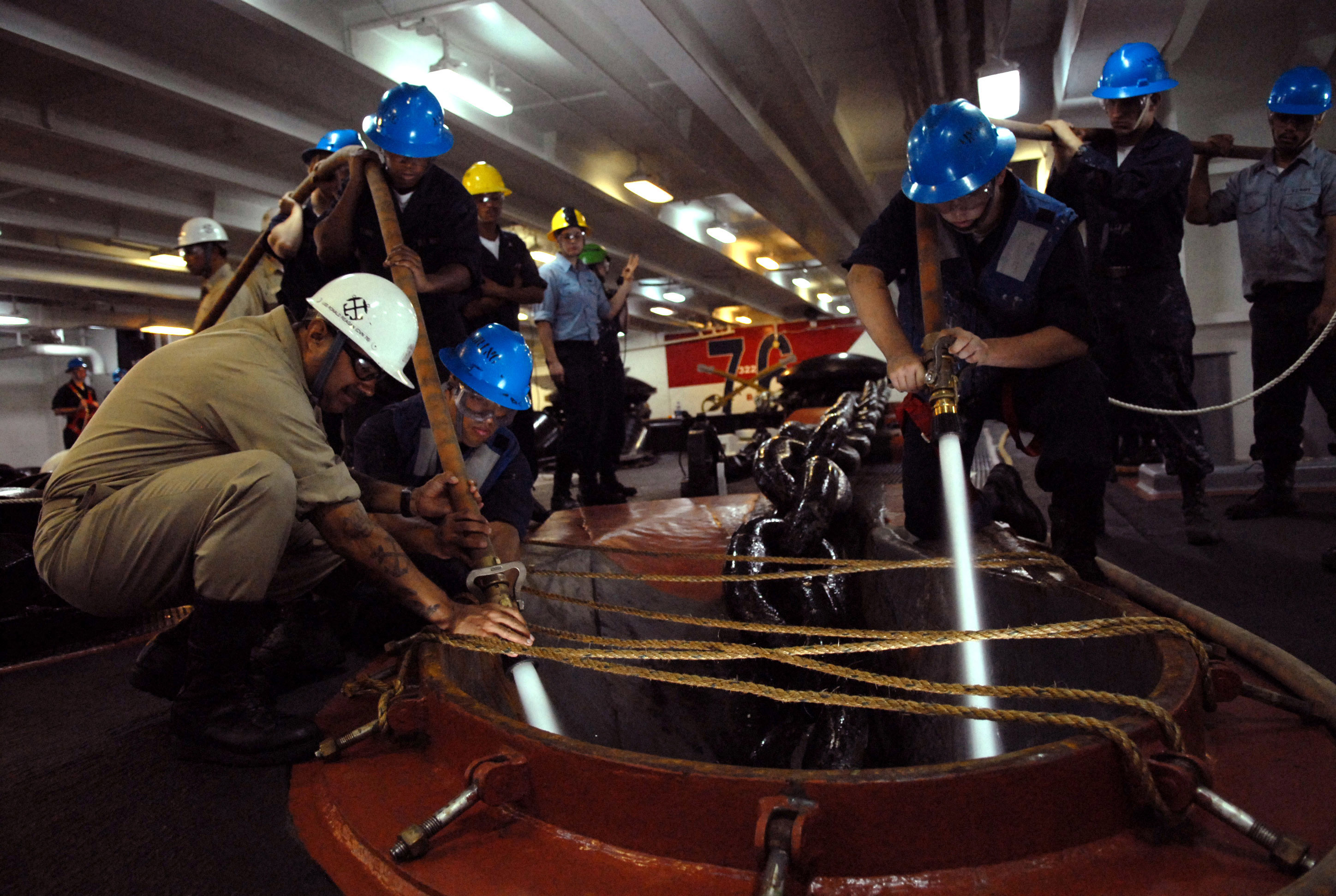 US Navy 060613-N-7711S-273 Deck Department personnel washes down an anchor chain from the foc'sle aboard the Nimitz-class aircraft carrier USS Ronald Reagan (CVN 76)