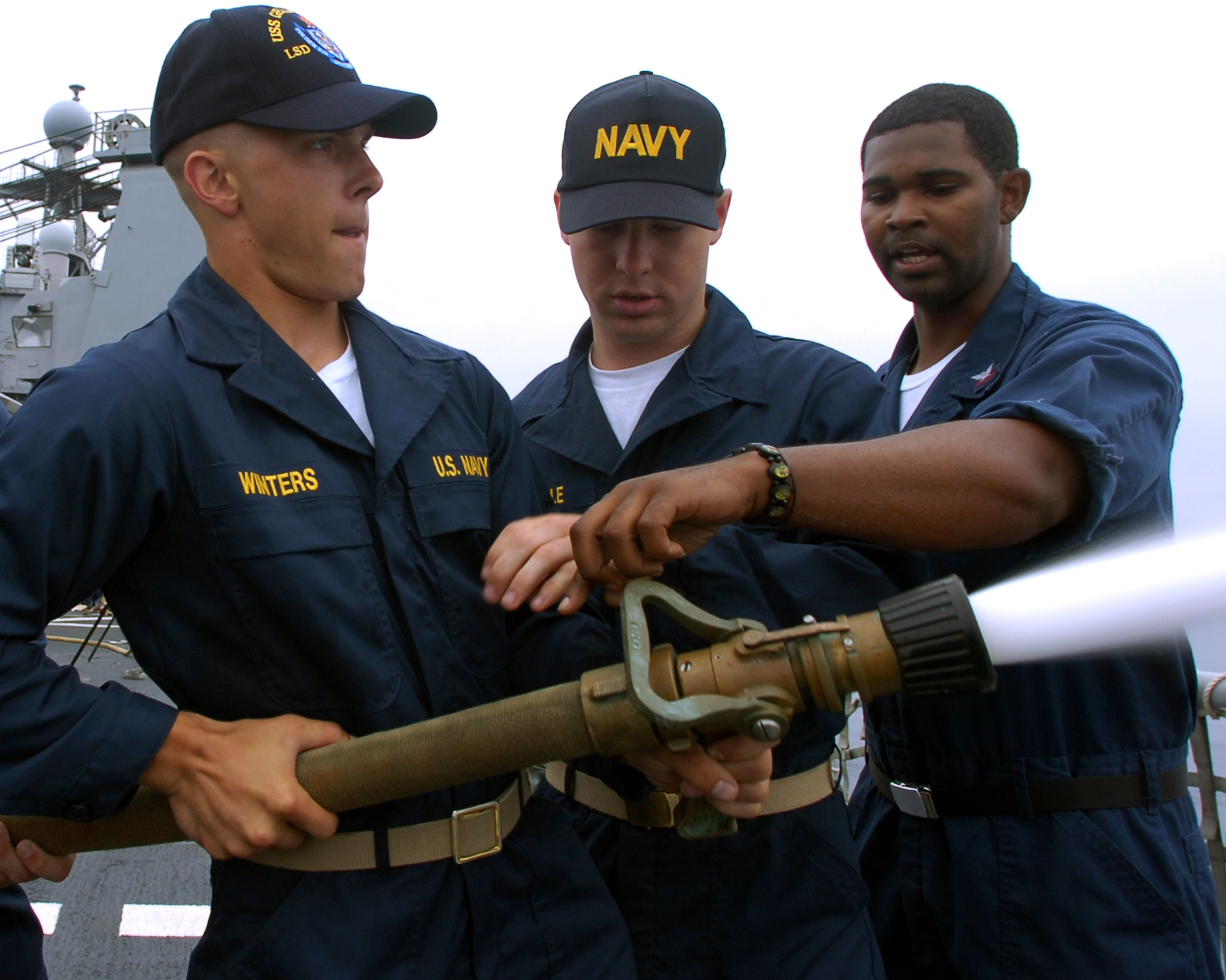 US Navy 070718-N-4163T-068 Damage Controlman 3rd Class Jason Chatman instructs midshipmen on the proper way to relieve the nozzelman on a firefighting hose