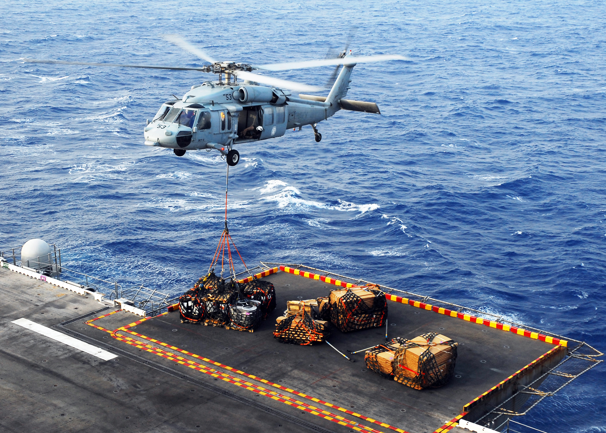US Navy 080831-N-2183K-044 An MH-60S Sea Hawk helicopter delivers crates of supplies to the amphibious assault ship USS Peleliu (LHA 5) during a vertical replenishment at sea