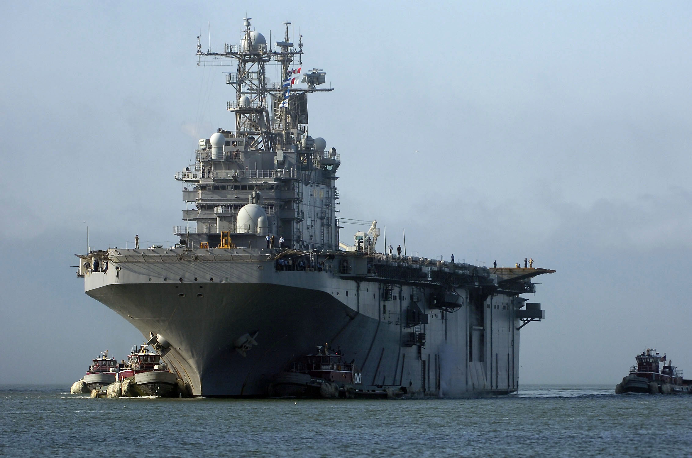 US Navy 080927-N-5758H-114 The amphibious assault ship USS Nassau (LHA 4) is escorted into Naval Station Norfolk