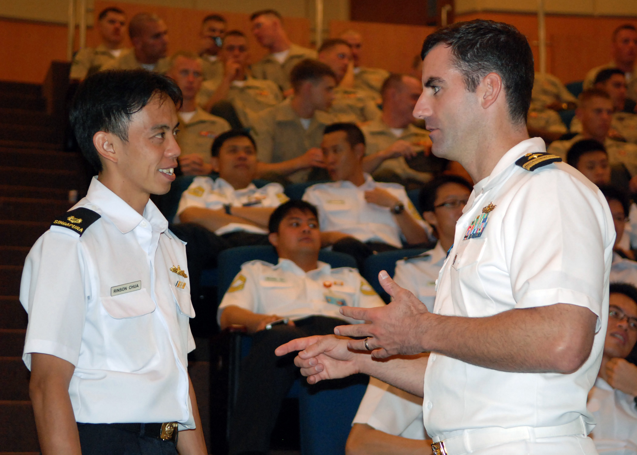 US Navy 090619-N-5207L-040 Republic of Singapore Navy Maj. Rinson Chua speaks with Lt. Cmdr. Greg Adams of Commander