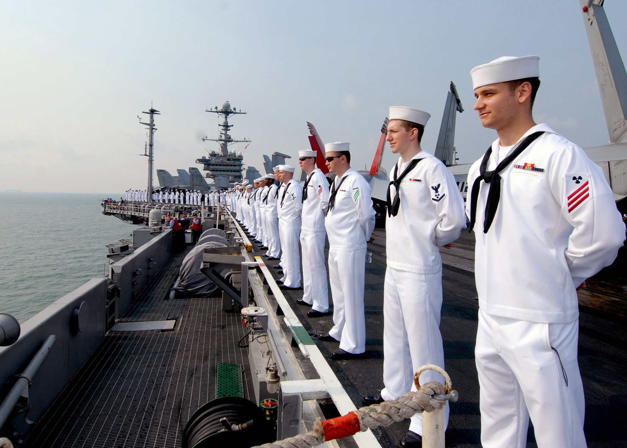 US Navy 090802-N-6720T-045 Sailors man the rails aboard the aircraft carrier USS George Washington (CVN 73) while underway off the coast of Singapore
