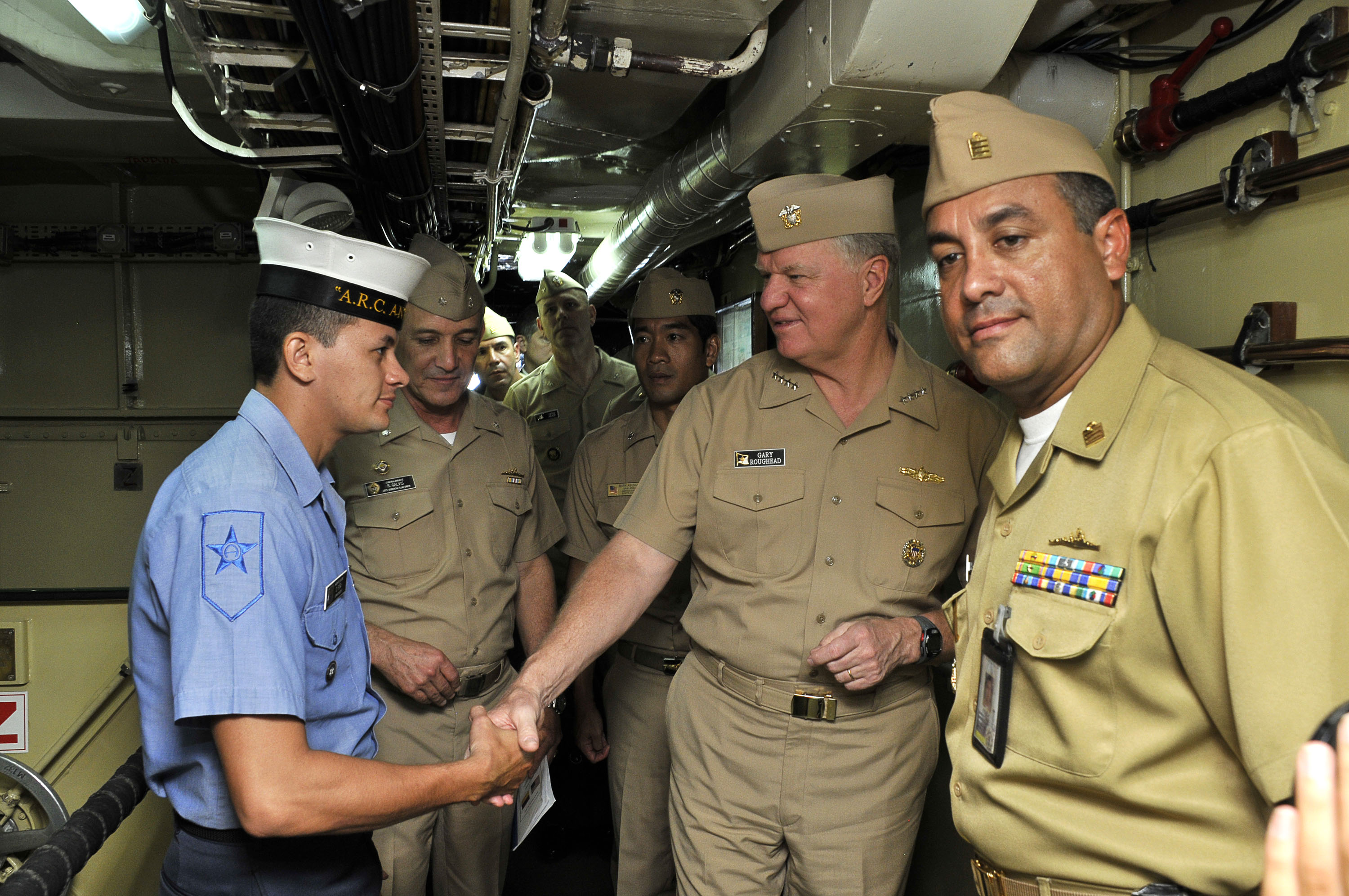 US Navy 091205-N-8273J-066 Chief of Naval Operations (CNO) Adm. Gary Roughead, middle, speaks with Columbian sailors while touring the Colombian navy frigate ARC Antioquia (FL 53)