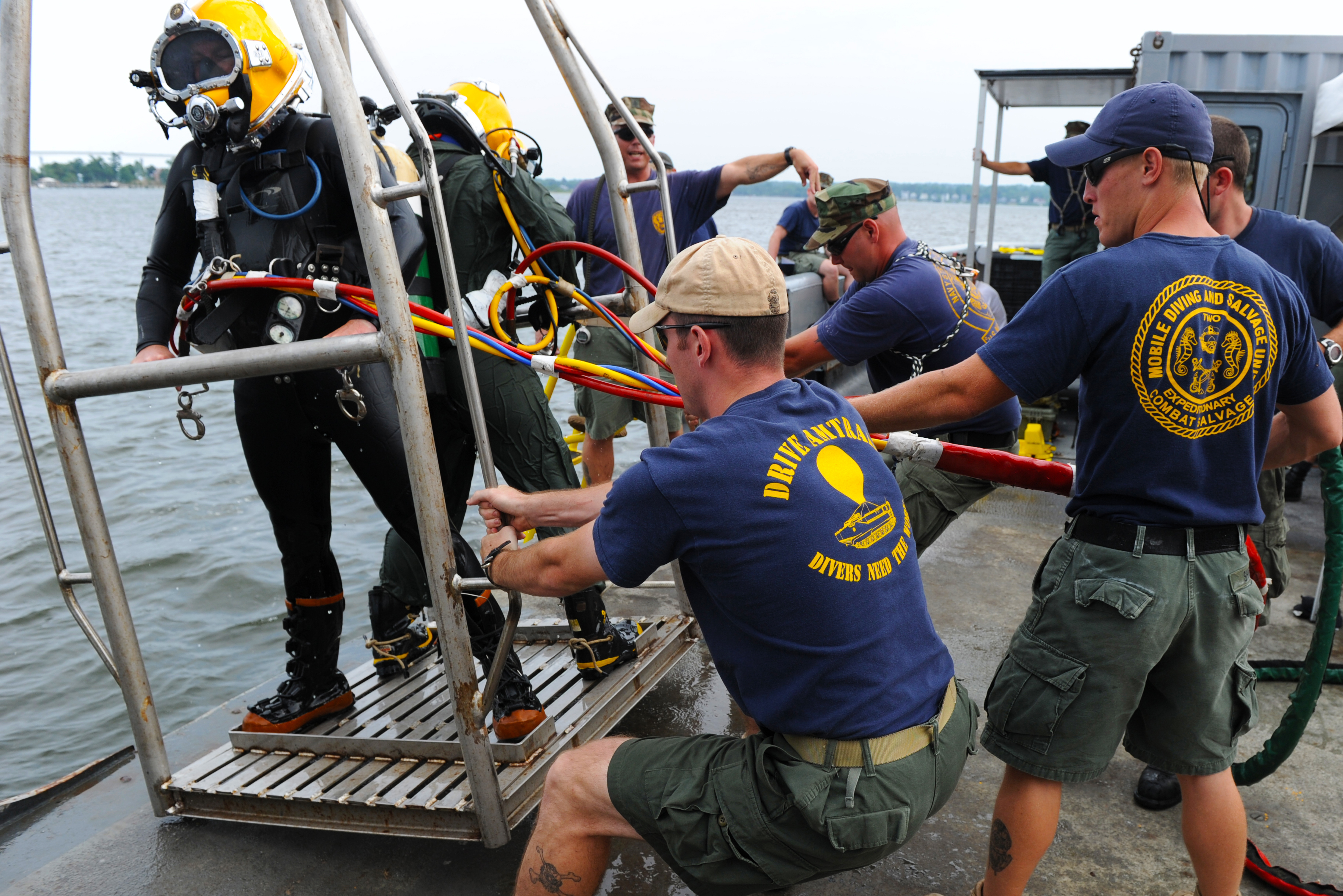 US Navy 100712-N-9769P-738 Navy Divers are pulled onto the Military Sealift Command fleet ocean tug USNS Apache (T-ATF 172) on a diving stage after a dive