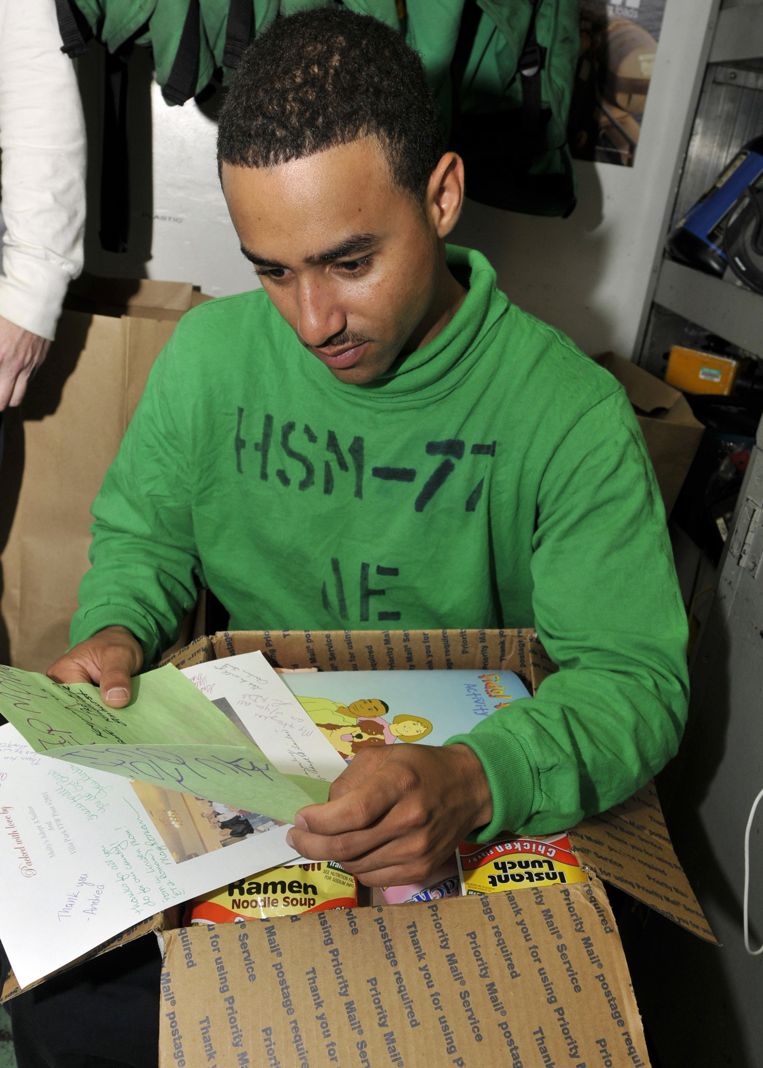 US Navy 110221-N-ZN781-023 Aviation Electrician's Mate Airman David Coley, from Rocky Mount, N.C., reads a letter aboard the aircraft carrier USS A