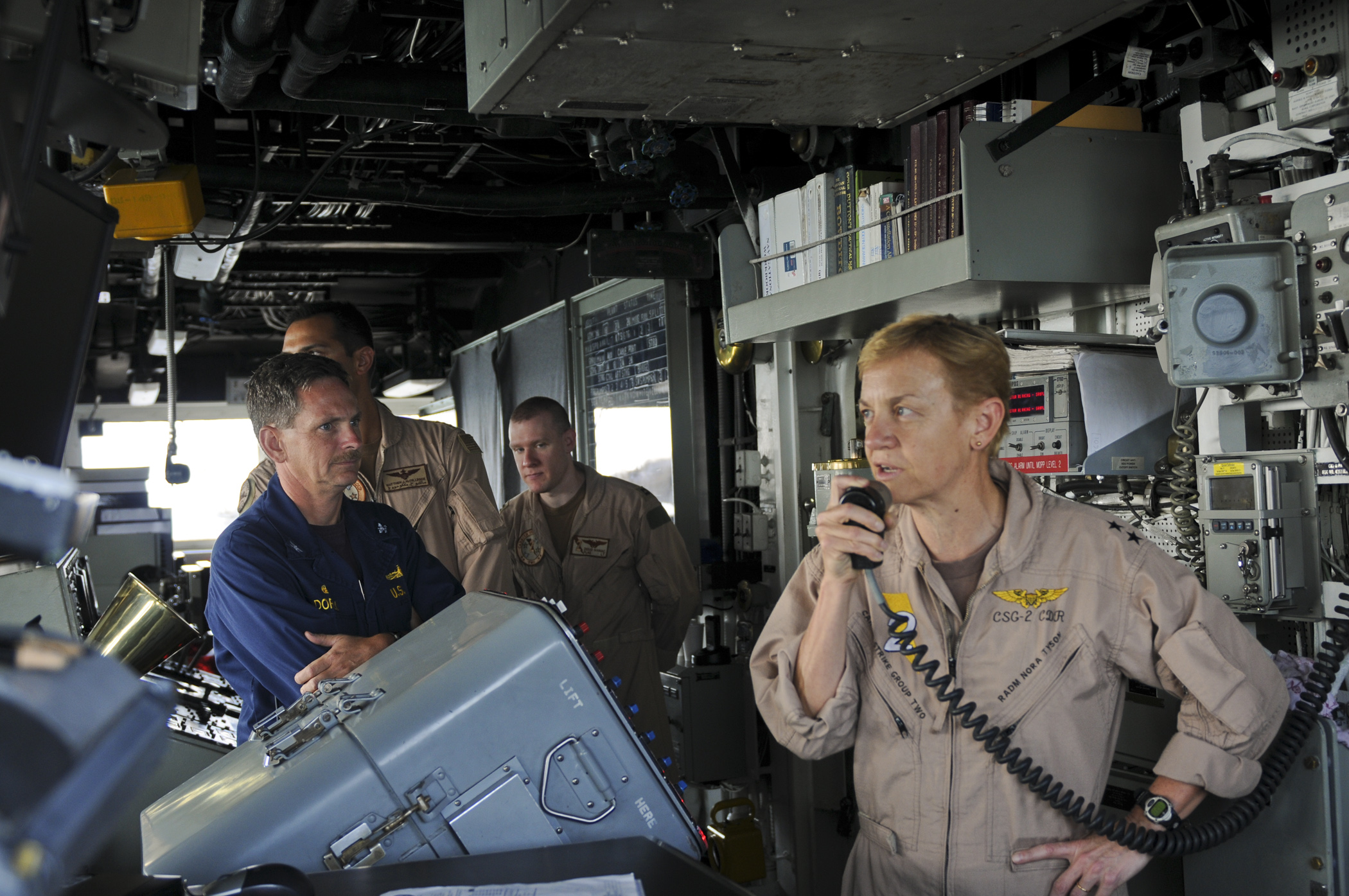 US Navy 111003-N-YM590-026 Rear Adm. Nora Tyson, commander of Carrier Strike Group (CSG) 2, right, addresses the crew of the guided-missile cruiser