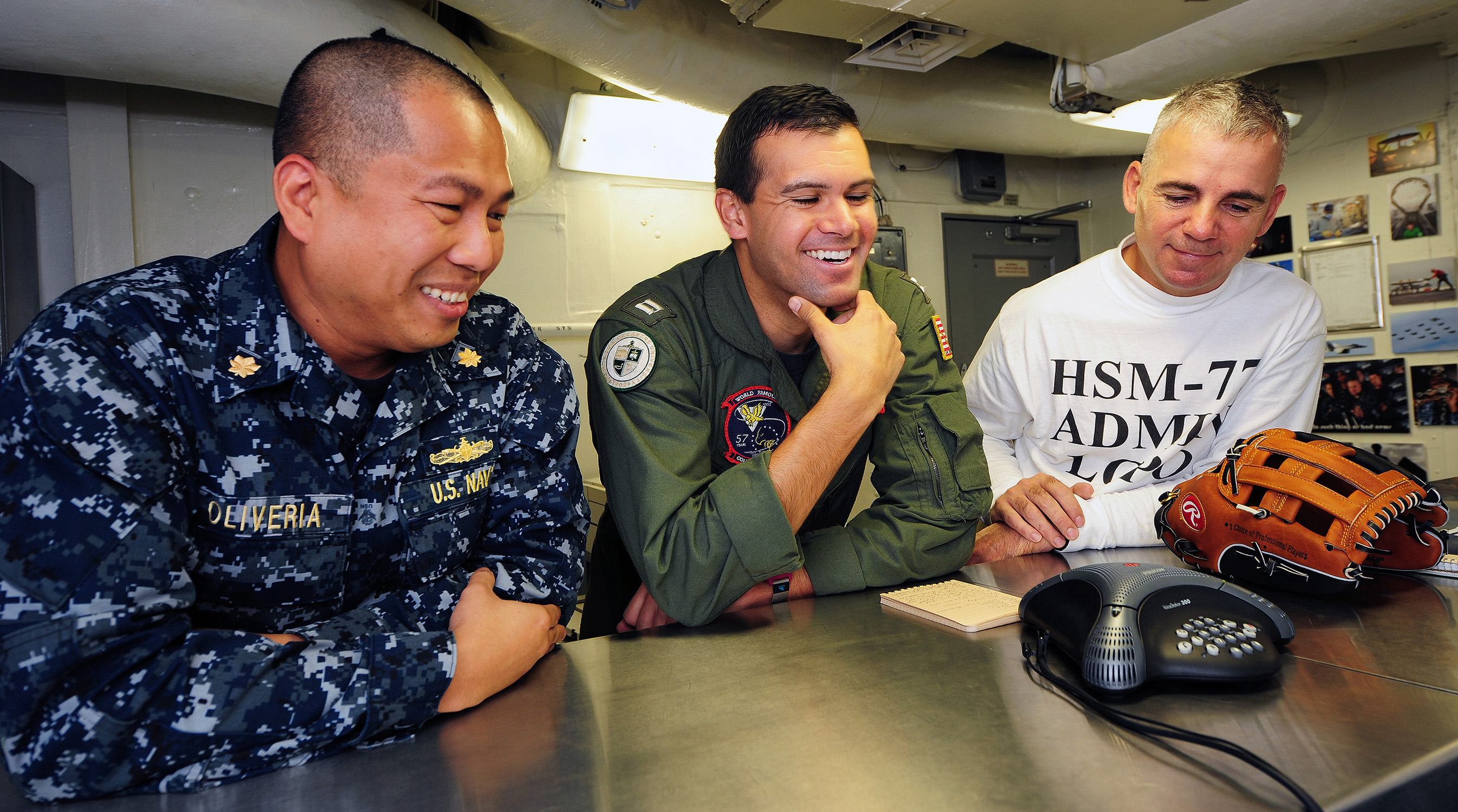 US Navy 111220-N-KQ416-025 Lt. Cmdr. Tristan Oliveria, Lt. Michael Chalfant and Chief Yeoman Ken Ingle ask San Diego Padres catcher Nick Hundley qu