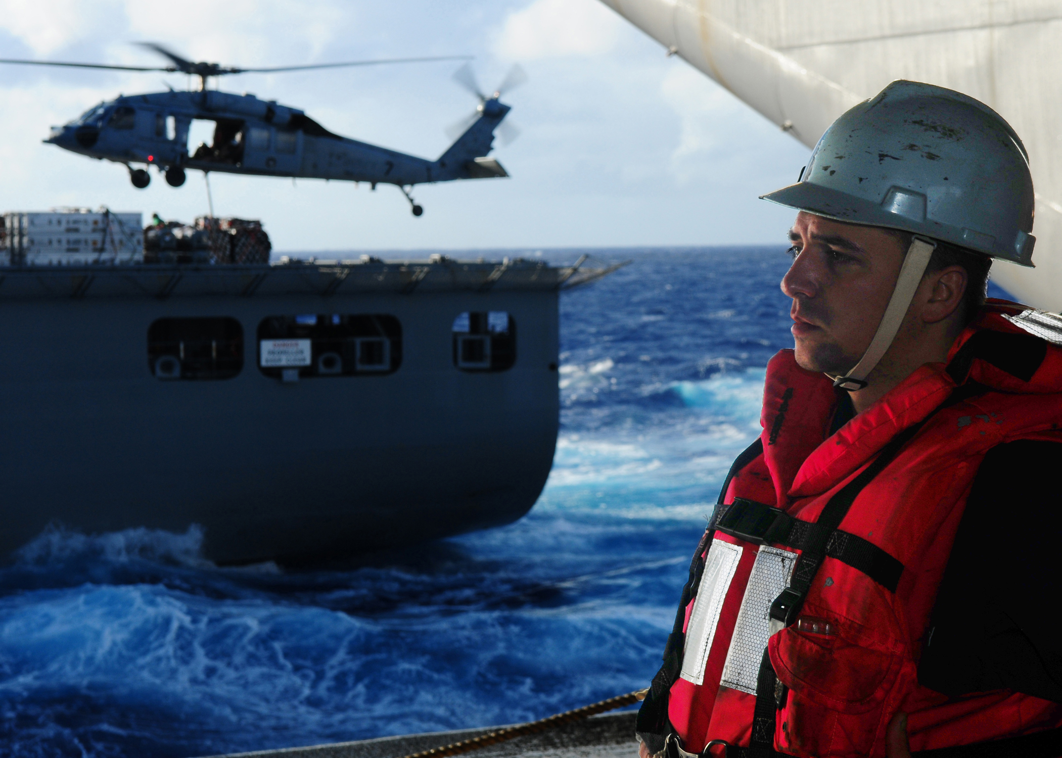 US Navy 111228-N-SK590-110 Boatswain's Mate Seaman Apprentice Preston Parr waits for supplies to come across a phone and distance line during a rep
