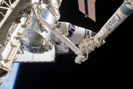 A partial view of the space shuttle Atlantis (STS-129), docked to the International Space Station, along with the station's Canadarm2, the Columbus laboratory and Harmony node are featured in this image photographed by a space-walking astronaut during the mission's third and final spacewalk.