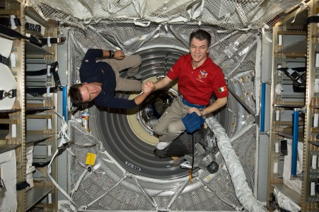 Onboard the International Space Station, European Space Agency astronauts Paolo Nespoli (left) and Roberto Vittori shake hands following an Earth-to-space phone tag-up with Italian President Giorgio Napolitano. Nespoli has been on the station for over five months and is due to return to Earth in less than 24 hours. Vittori is on a 16-day mission of the space shuttle Endeavour, joined by five NASA astronauts. This occasion is the second time two Italian astronauts have been in space together and the first time in the last 15 years.