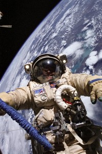 Astronaut Edward M. (Mike) Fincke, Expedition 9 NASA ISS science officer and flight engineer, wearing a Russian Orlan spacesuit, participates in the third of four sessions of extravehicular activities (EVA) performed by the Expedition 9 crew during their six-month mission. Fincke and cosmonaut Gennady I. Padalka (out of frame), commander representing Russia's Federal Space Agency, spent 4 ВЅ hours outside the Station swapping out experiments and installing hardware associated with EuropeвЂ™s Automated Transfer Vehicle (ATV), scheduled to launch on its maiden voyage to ISS next year. A cloudy Earth provided the backdrop for the image. According to a label on his chest, he is wearing a Orlan-M suit.