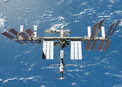 Backdropped by a blue and white Earth, the International Space Station is seen in this image taken by a crew member on the Space Shuttle Endeavour during STS-130, after the station and shuttle began their post-undocking relative separation. Undocking of the two spacecraft occurred at 19:54 EST on 19 February 2010. The two newest modules to be added to the station, Tranquillity and the Cupola, can be seen nestled beneath the Integrated Truss Structure, docked to Unity.