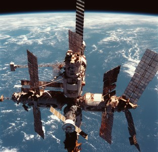 Russia's Mir space station is backdropped over the blue and white planet Earth in this medium range photograph recorded during the final fly-around of the members of the fleet of NASA's shuttles. Seven crew members, including Andrew S.W. Thomas, were aboard the Discovery when the photo was taken; and two of his former cosmonaut crewmates remained aboard Mir. Thomas ended up spending 141 days in space on this journey, including time aboard the Space Shuttles Endeavour and Discovery, which delivered and retrieved him to and from the Mir.