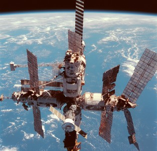 Russia's Mir space station is backdropped over the blue and white planet Earth in this medium range photograph recorded during the final fly-around of the members of the fleet of NASA's shuttles. Seven crew members, including Andrew S.W. Thomas, were aboard the Space Shuttle Discovery when the photo was taken; and two of his former cosmonaut crewmates remained aboard Mir. Thomas ended up spending 141 days in space on this journey, including time aboard Space Shuttles Endeavour and Discovery, which transported him to and from Mir.