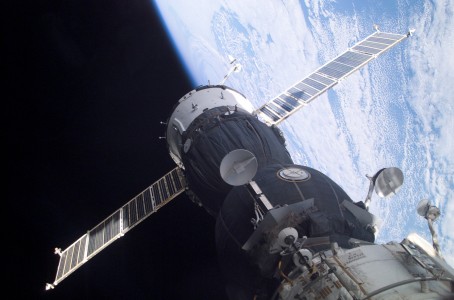 A Soyuz spacecraft, which carried the Soyuz 5 taxi crew, is docked to the Pirs docking compartment on the International Space Station (ISS). The new Soyuz TMA-1 vehicle was designed to accommodate larger or smaller crewmembers, and is equipped with upgraded computers, a new cockpit control panel and improved avionics. The blackness of space and EarthвЂ™s horizon provide the backdrop for the scene.