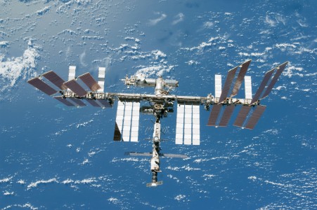 Backdropped by a blue and white part of Earth, the International Space Station is featured in this image photographed by an STS-130 crew member on space shuttle Endeavour after the station and shuttle began their post-undocking relative separation. Undocking of the two spacecraft occurred at 7:54 p.m. (EST) on Feb. 19, 2010.